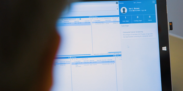While checking in a patient's EMR, Holon taps Dr. Spencer on the shoulder with some care gaps