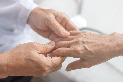 Doctor holding a patients hand