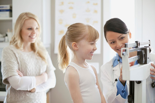 Physician weighting a child